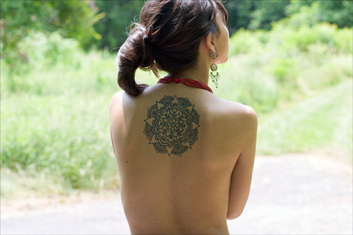 young woman with tattoo on her back